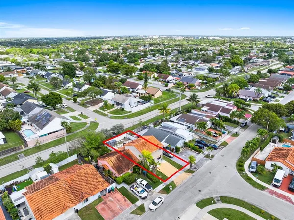 an aerial view of residential houses with outdoor space