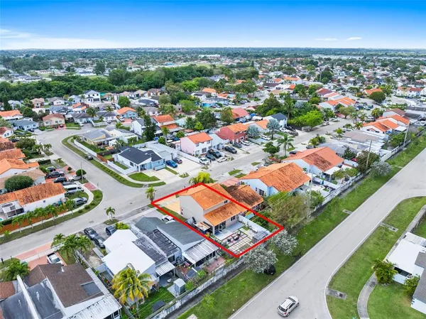 an aerial view of residential houses with outdoor space
