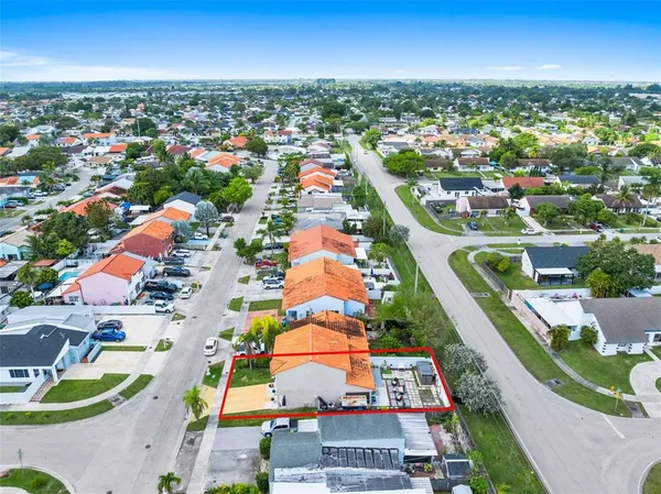 an aerial view of residential houses with outdoor space