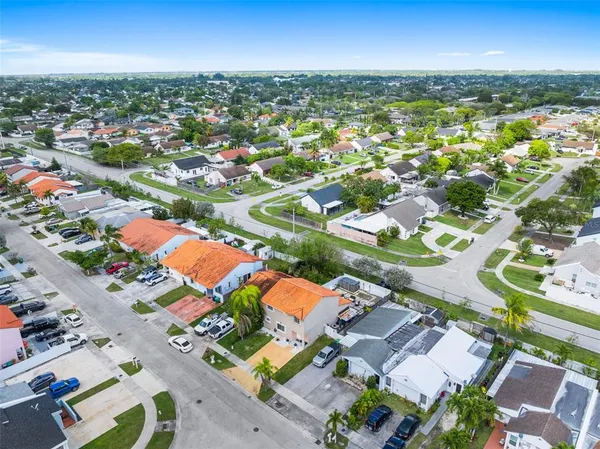 an aerial view of residential houses with outdoor space
