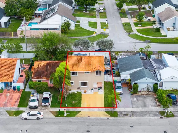 an aerial view of houses with yard