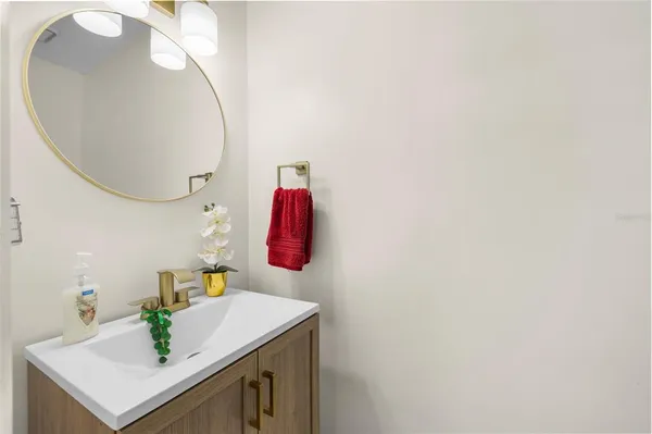 a bathroom with a sink vanity and a mirror