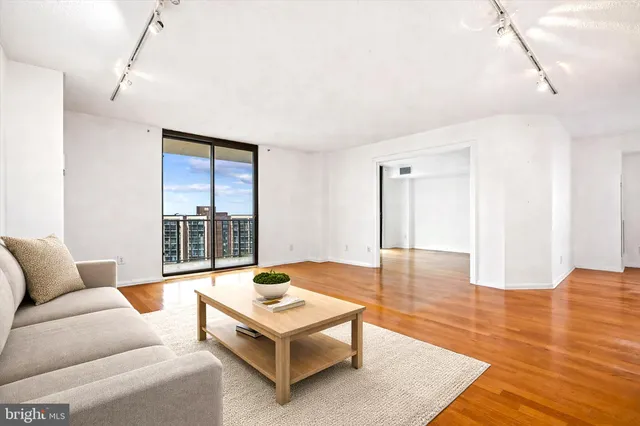 an empty room with windows and cabinet