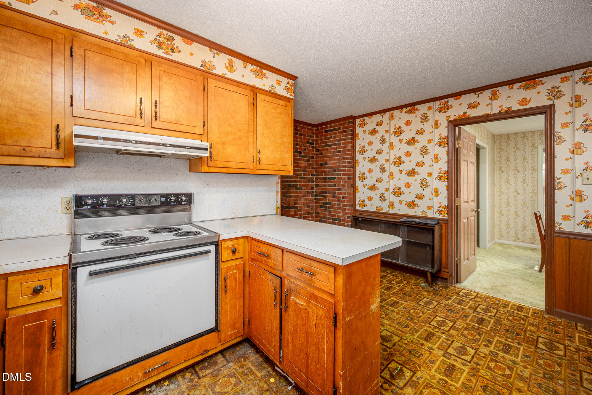 4411 Rhew Drive Durham, NC 27704 - Photo 15 of 34 a kitchen with stainless steel appliances granite countertop a sink stove and cabinets