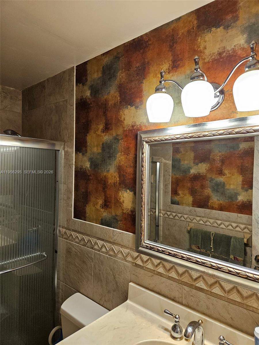 10301 Greenbriar Court Boca Raton, FL 33498 - Photo 13 of 43 a bathroom with a toilet and a mirror