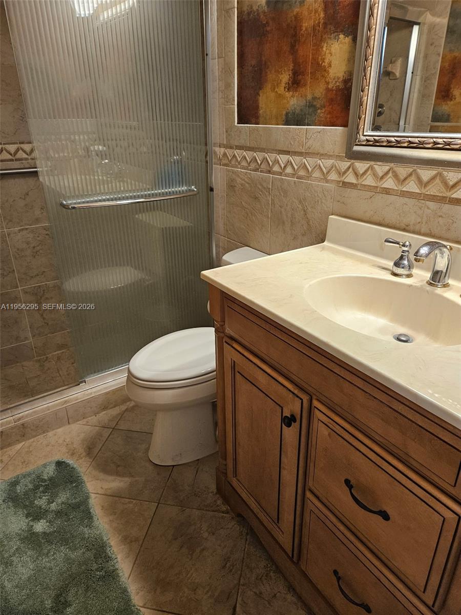 10301 Greenbriar Court Boca Raton, FL 33498 - Photo 14 of 43 a bathroom with a sink and a toilet