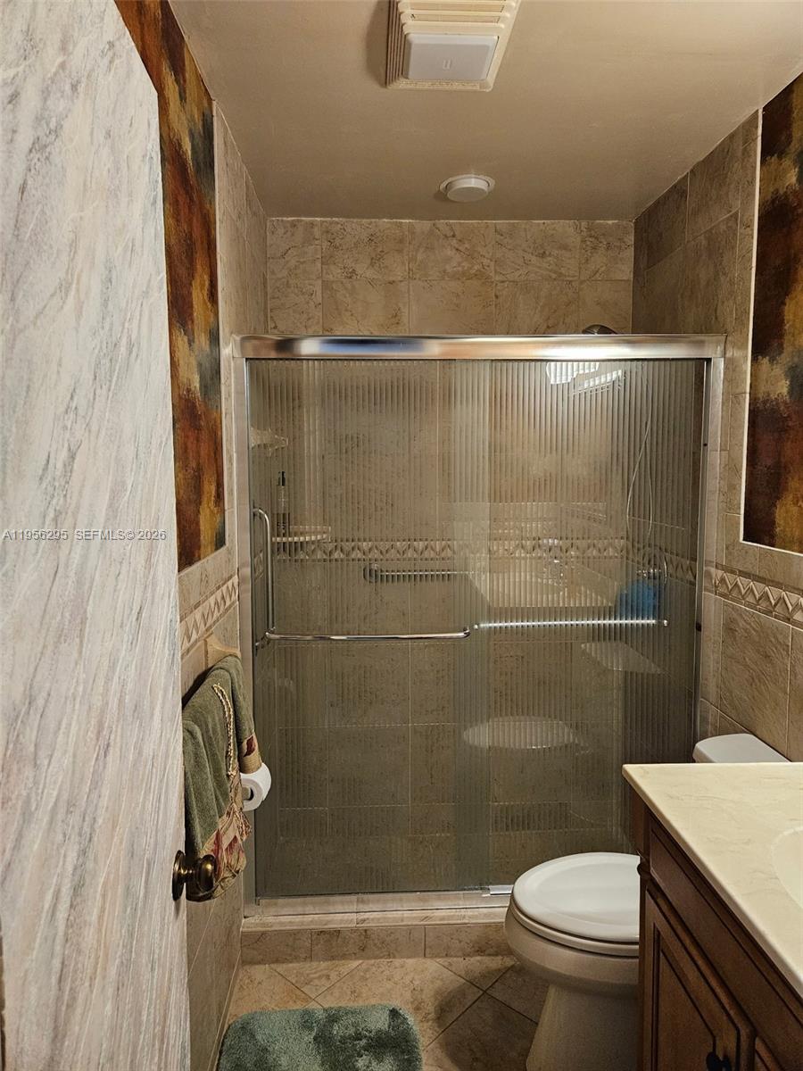 10301 Greenbriar Court Boca Raton, FL 33498 - Photo 16 of 43 a bathroom with a shower a toilet and a sink