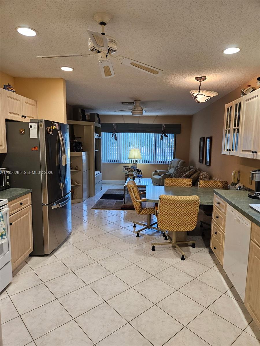 10301 Greenbriar Court Boca Raton, FL 33498 - Photo 19 of 43 a living room with furniture and kitchen area