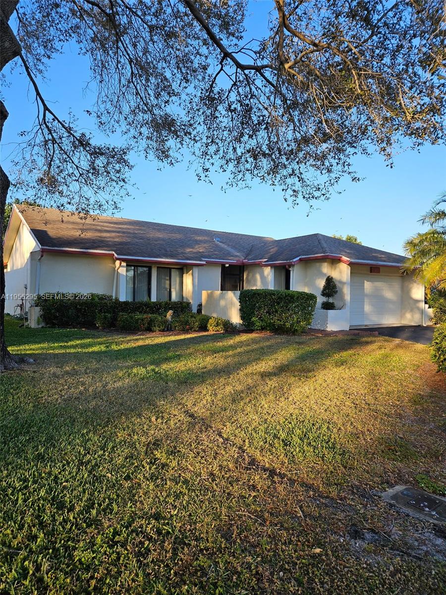 10301 Greenbriar Court Boca Raton, FL 33498 - Photo 2 of 43 a front view of a house with a yard