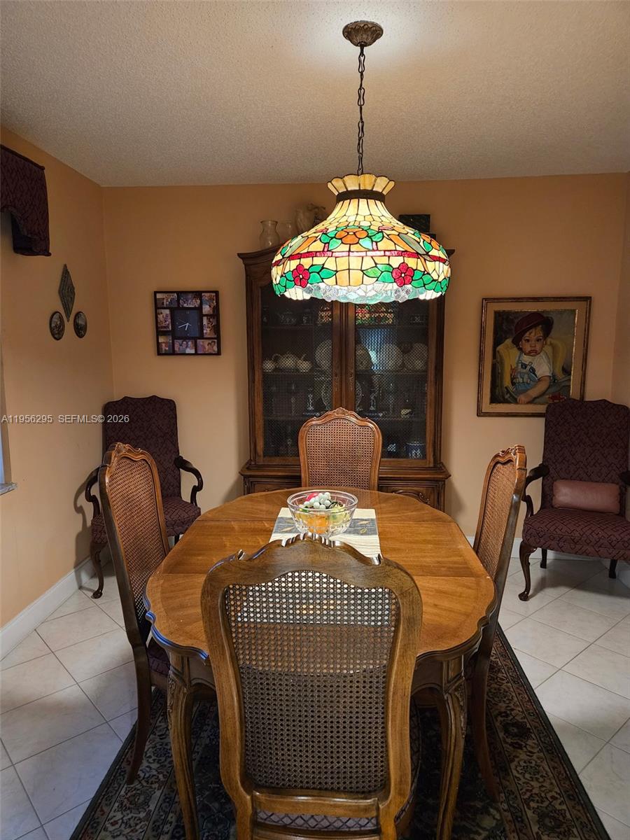 10301 Greenbriar Court Boca Raton, FL 33498 - Photo 22 of 43 a bedroom with a bed and a chandelier