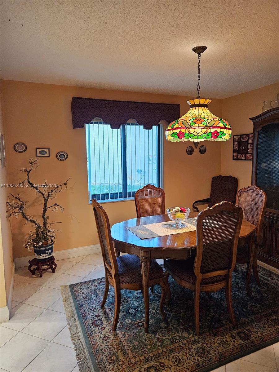 10301 Greenbriar Court Boca Raton, FL 33498 - Photo 23 of 43 a view of a dining room with furniture window and wooden floor