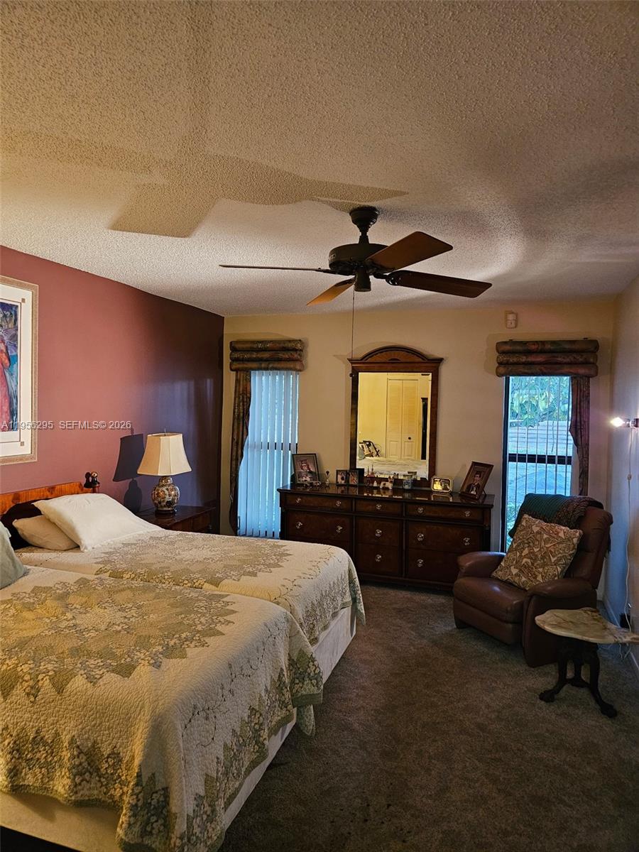 10301 Greenbriar Court Boca Raton, FL 33498 - Photo 26 of 43 a bed room with a bed and a couch