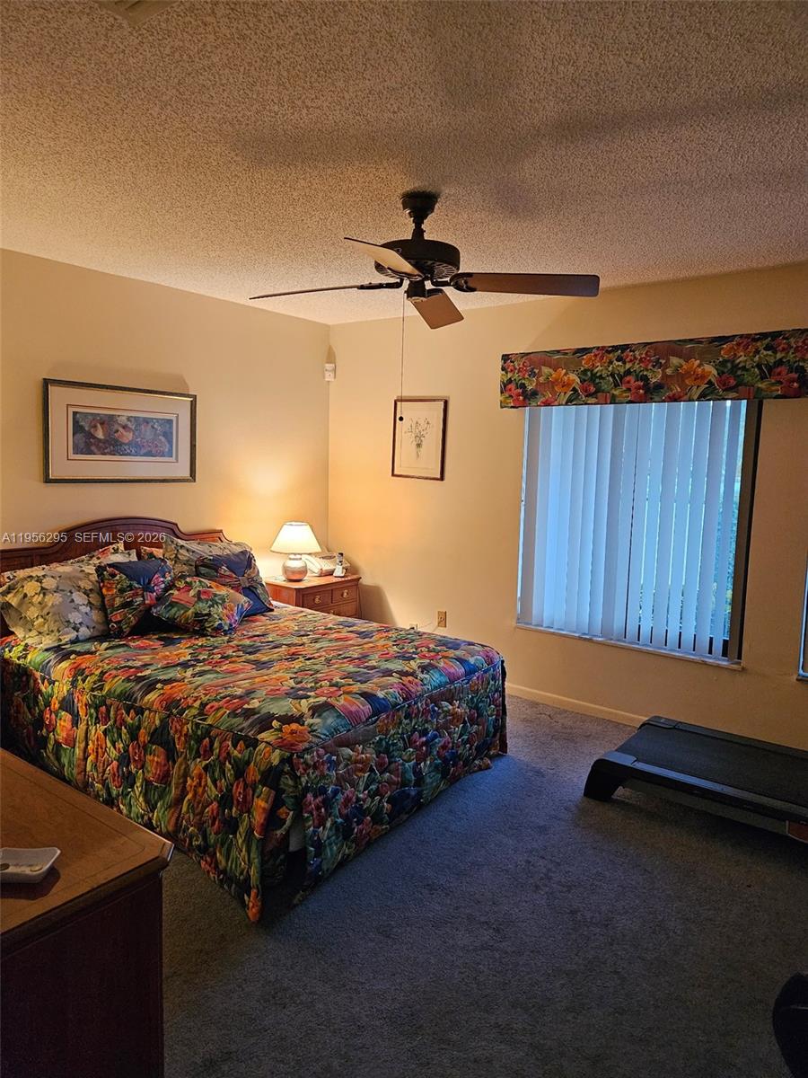 10301 Greenbriar Court Boca Raton, FL 33498 - Photo 27 of 43 a bed room with a bed and a chair