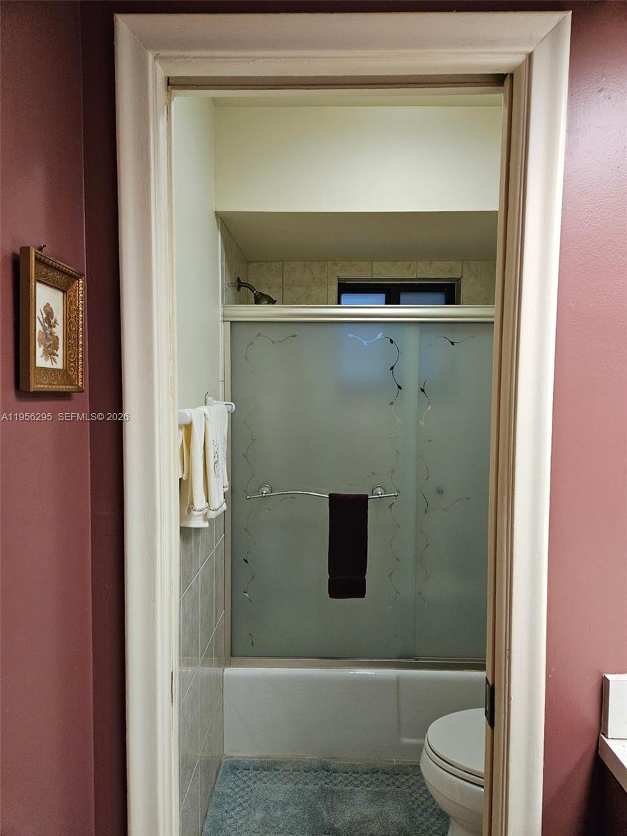 10301 Greenbriar Court Boca Raton, FL 33498 - Photo 30 of 43 a bathroom with a toilet and a shower