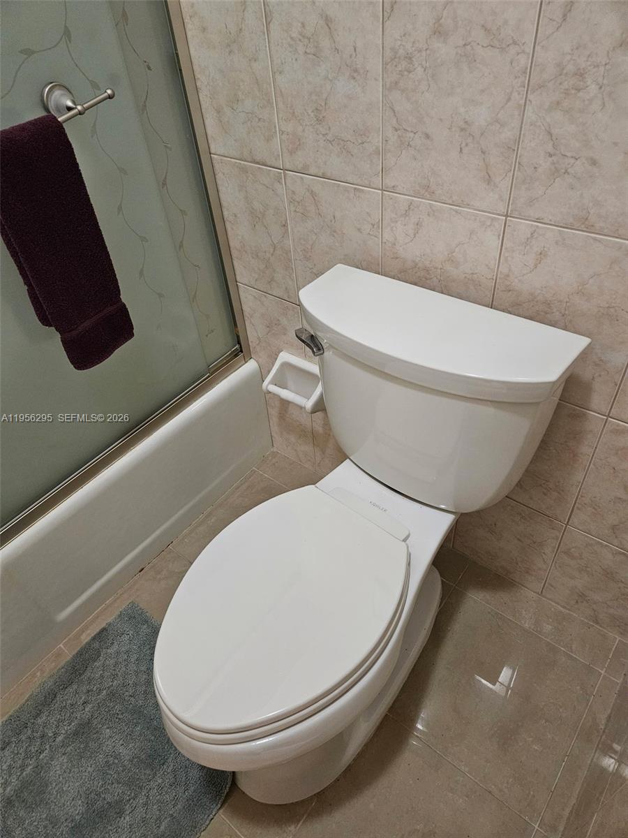 10301 Greenbriar Court Boca Raton, FL 33498 - Photo 31 of 43 a bathroom with a toilet and a rug