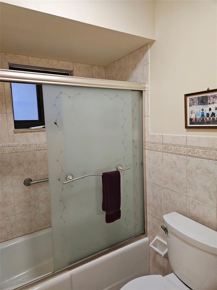 10301 Greenbriar Court Boca Raton, FL 33498 - Photo 36 of 43 a bathroom with a toilet and a shower