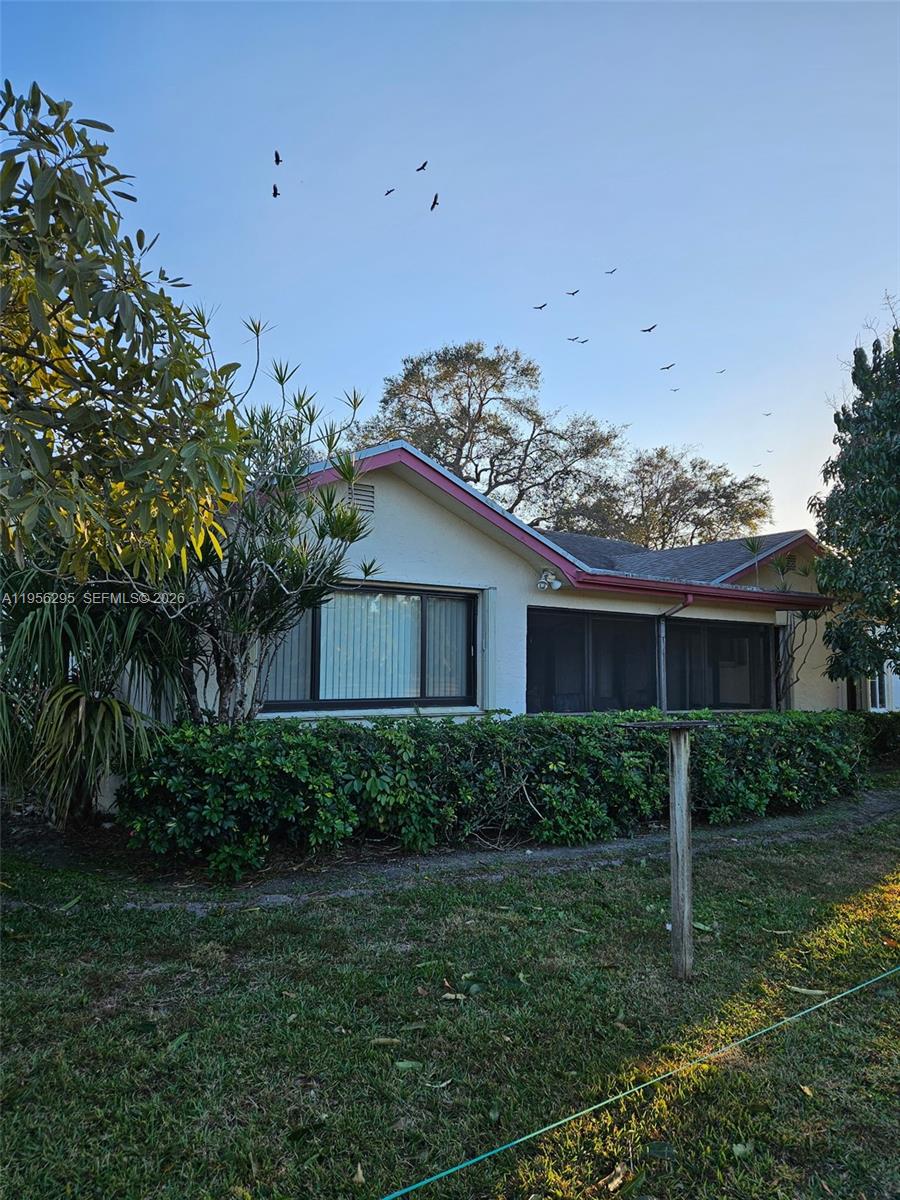 10301 Greenbriar Court Boca Raton, FL 33498 - Photo 4 of 43 a view of a house with a yard and plants