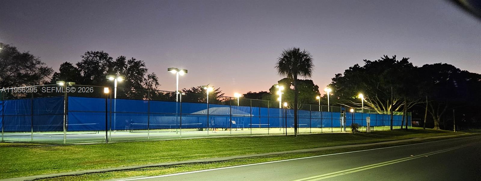 10301 Greenbriar Court Boca Raton, FL 33498 - Photo 41 of 43 a view of a tennis ground with large trees