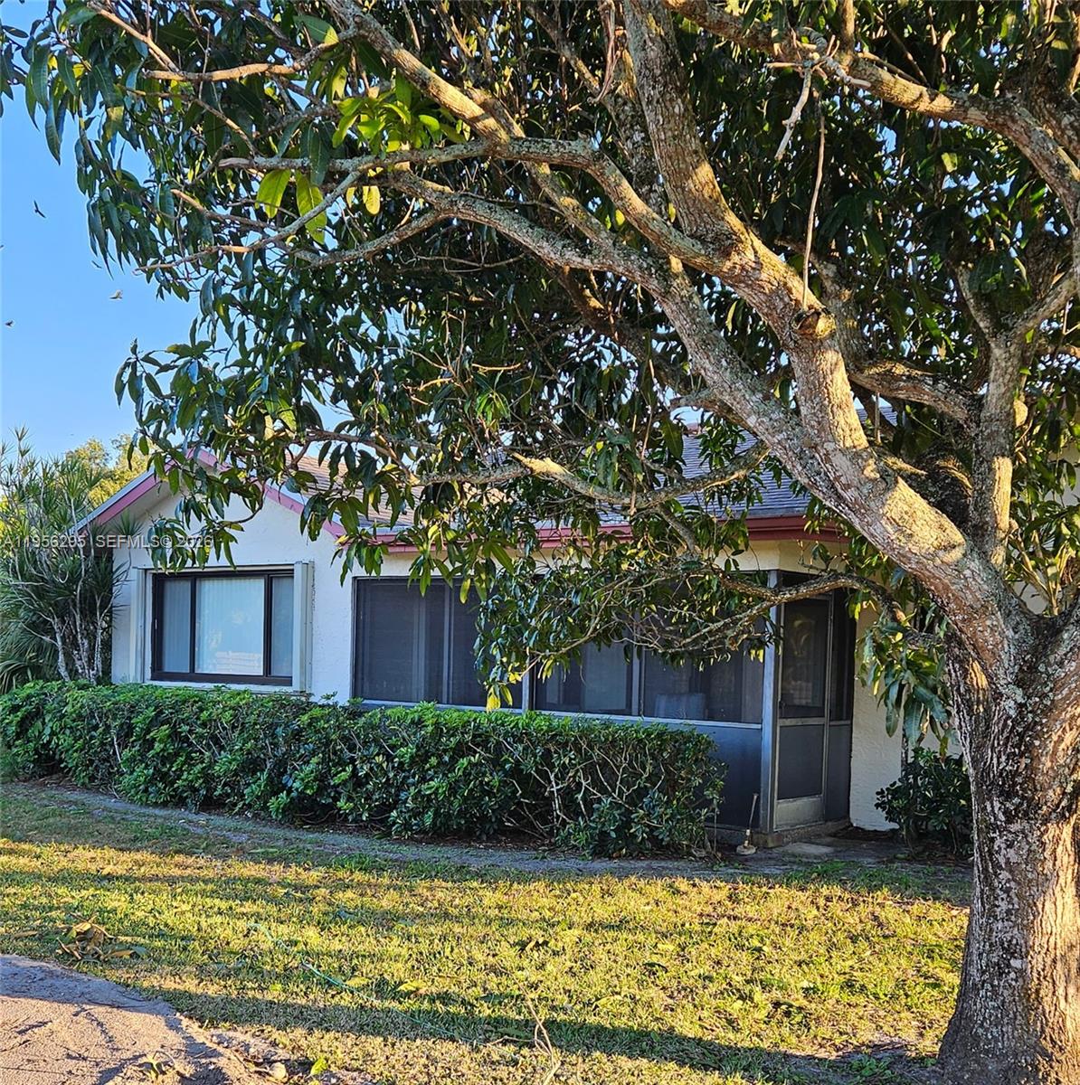 10301 Greenbriar Court Boca Raton, FL 33498 - Photo 5 of 43 a front view of a house with garden