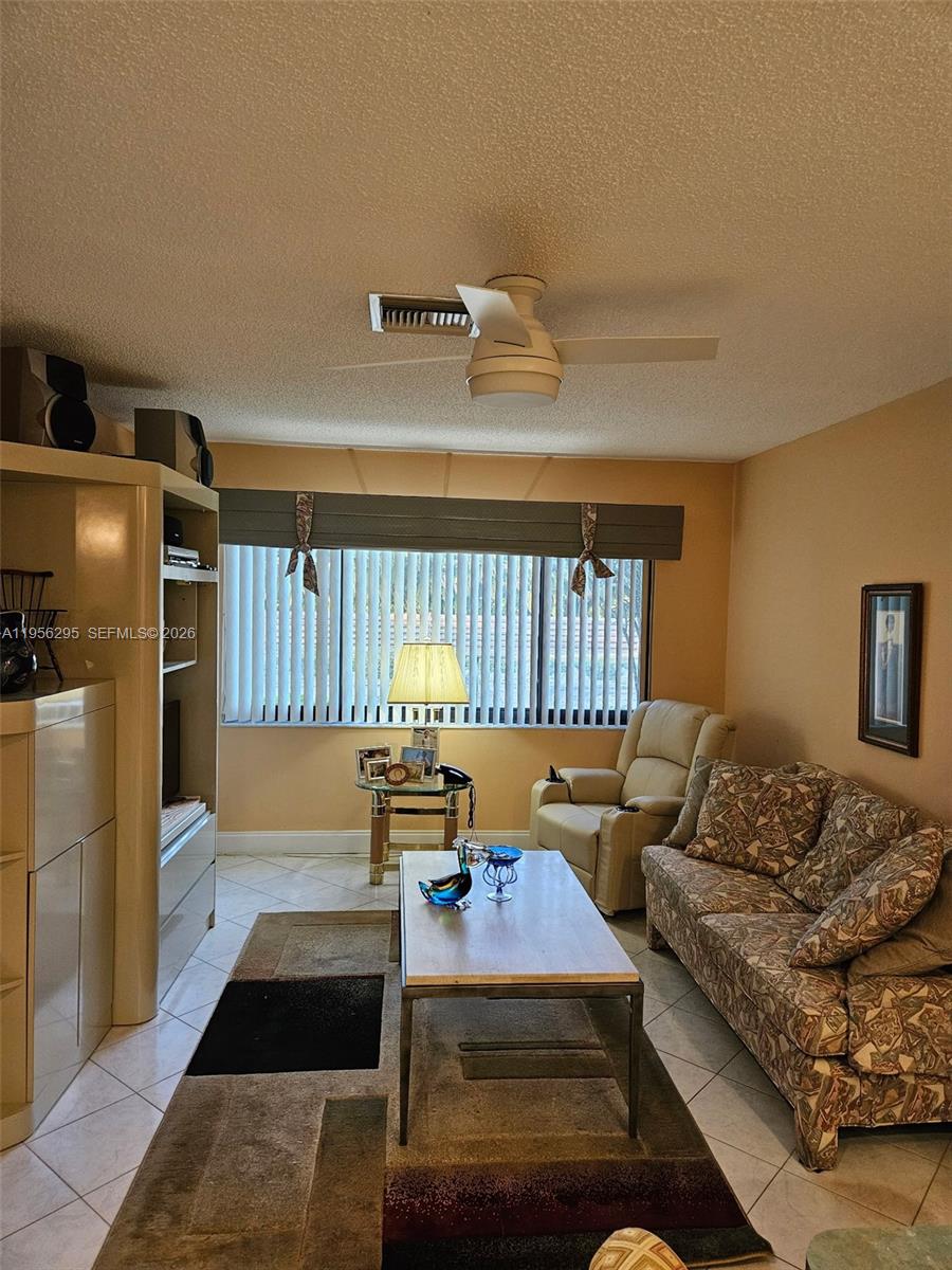 10301 Greenbriar Court Boca Raton, FL 33498 - Photo 9 of 43 a living room with furniture fireplace and a table