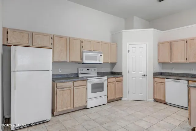 a kitchen with cabinets stainless steel appliances and a counter space