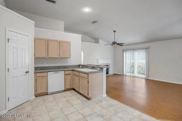 a kitchen with granite countertop white cabinets and white appliances
