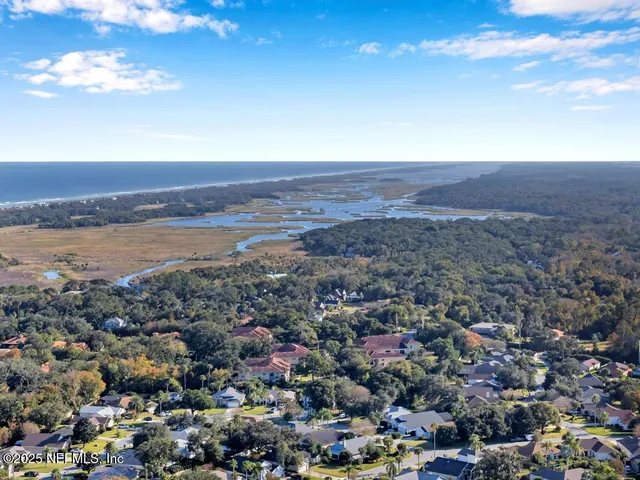 a front view of multi story residential apartment building with yard and sign board