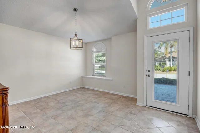 a view of a room with window and hallway