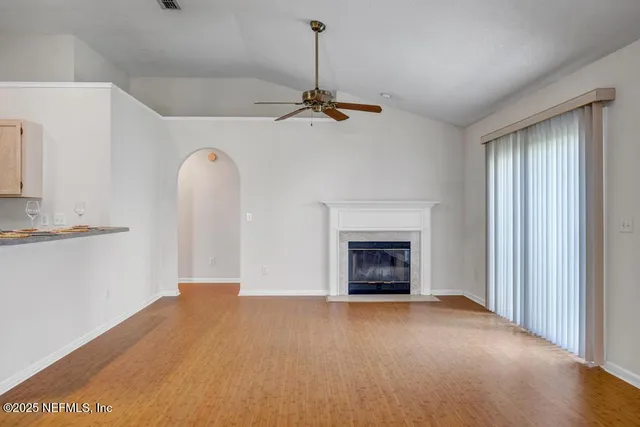 a view of empty room with a fireplace