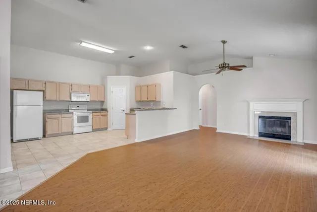 a view of a kitchen with a sink and a fireplace