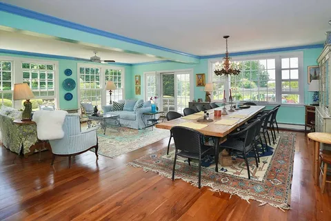 a view of a dining room with furniture window and wooden floor
