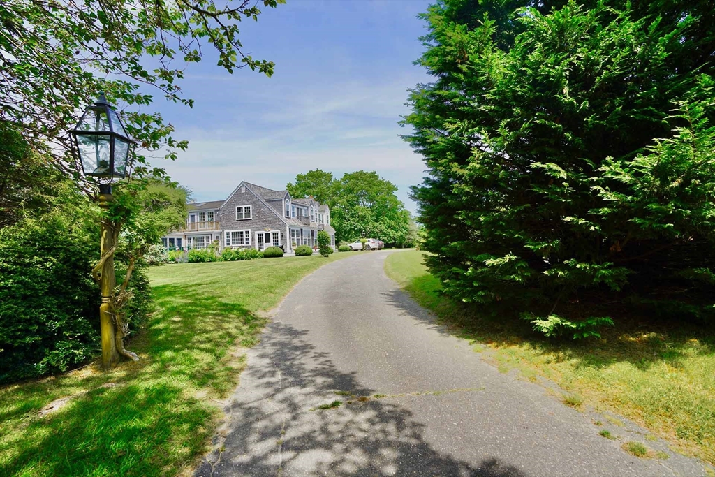 1 Louis Field Road Edgartown, MA 02539 - Photo 6 of 23 a view of a garden with a fountain