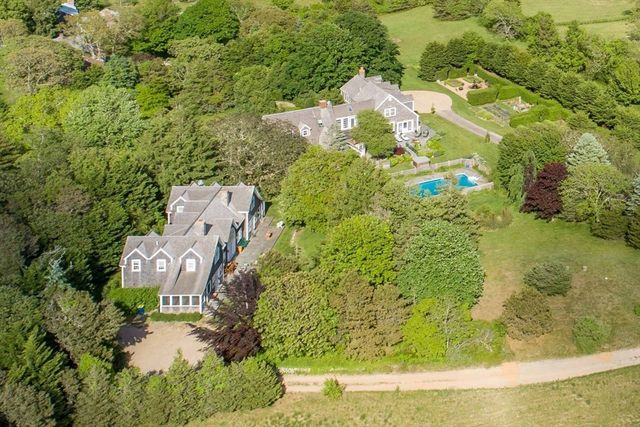 an aerial view of a house with a yard