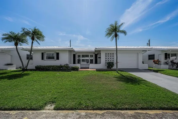 a front view of house with yard and outdoor seating