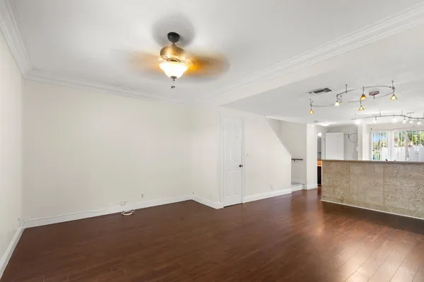 a view of a room with wooden floor