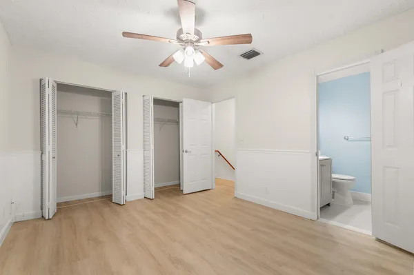 a view of a room with a stylish ceiling fan and entryway