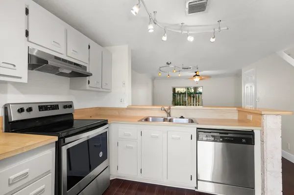 a kitchen with cabinets appliances and a sink