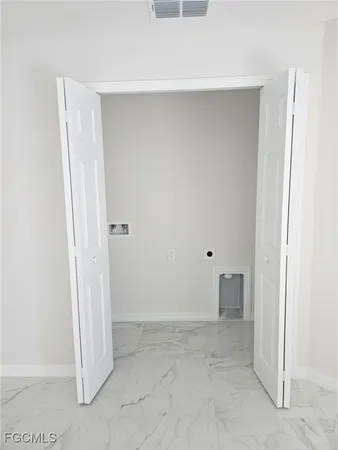 an empty room with an entrance to other room