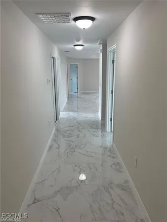 en empty room with window and entrance