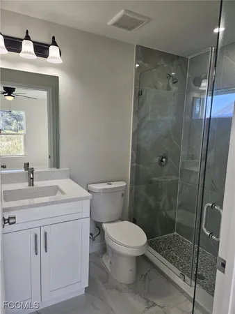a bathroom with a sink toilet and shower