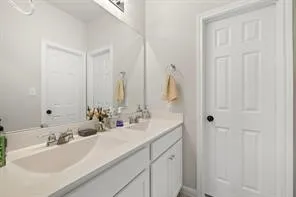 a bathroom with double sink and a mirror