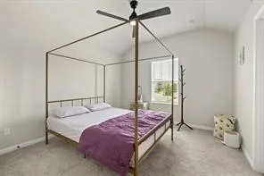 a bed sitting in a bedroom next to a window