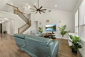 a living room with furniture and a potted plant