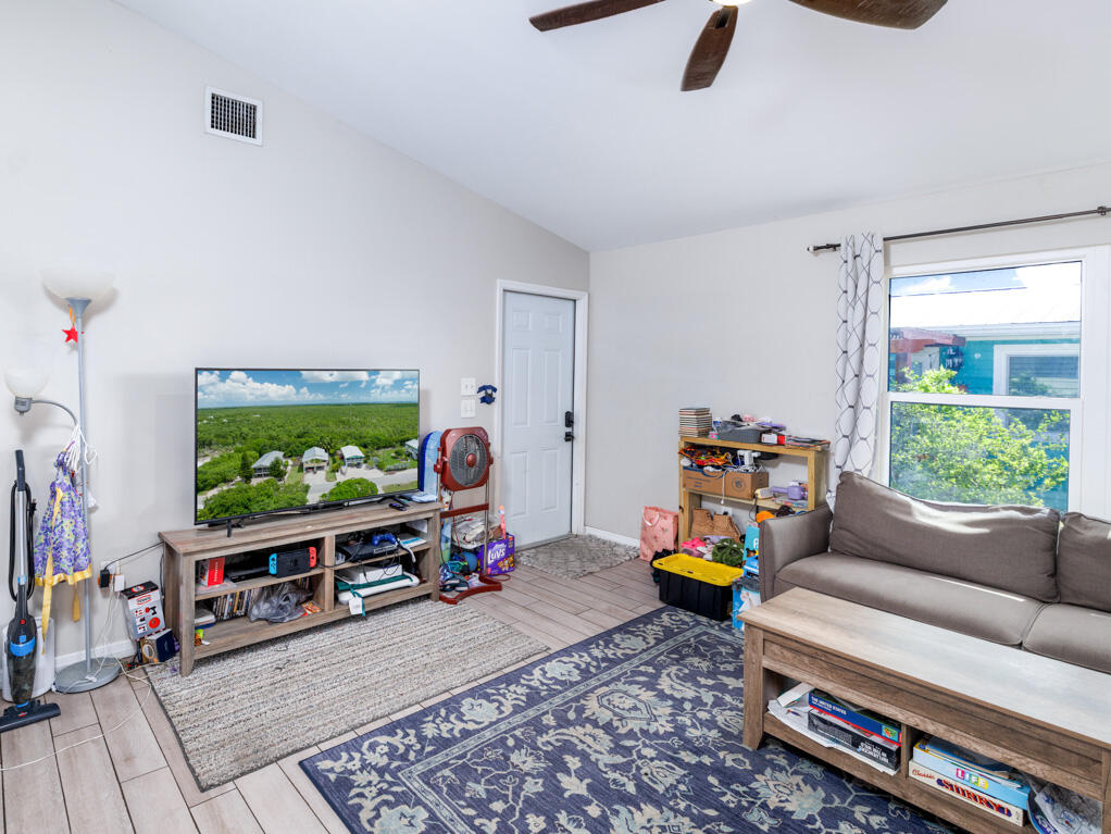 29283 Coconut Palm Drive Big Pine Key, FL 33043 - Photo 11 of 35 a living room with furniture and a flat screen tv
