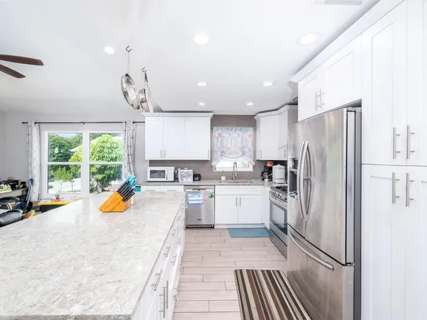 a kitchen with a refrigerator a sink and cabinets