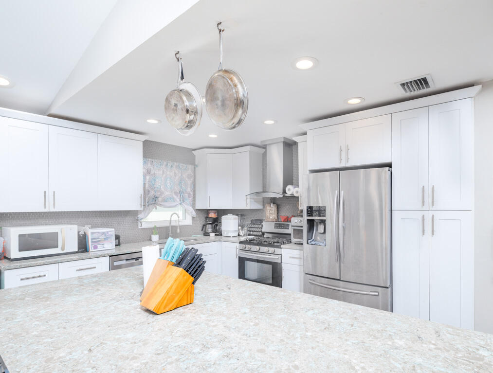 29283 Coconut Palm Drive Big Pine Key, FL 33043 - Photo 14 of 35 a kitchen with stainless steel appliances granite countertop a refrigerator a stove a sink and a refrigerator
