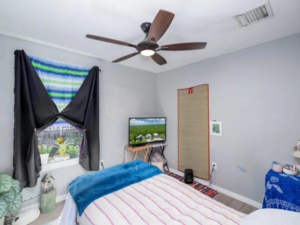 a bedroom with a bed and a window