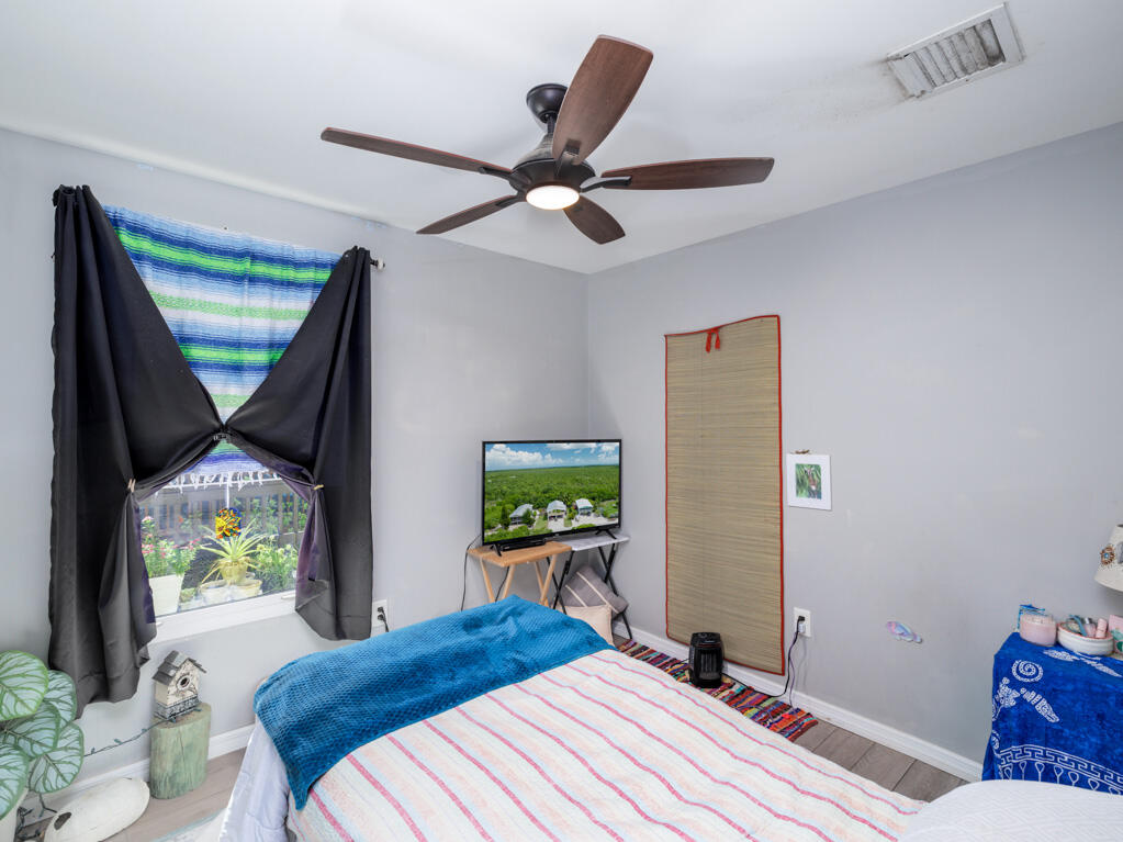 29283 Coconut Palm Drive Big Pine Key, FL 33043 - Photo 19 of 35 a bedroom with a bed and a window