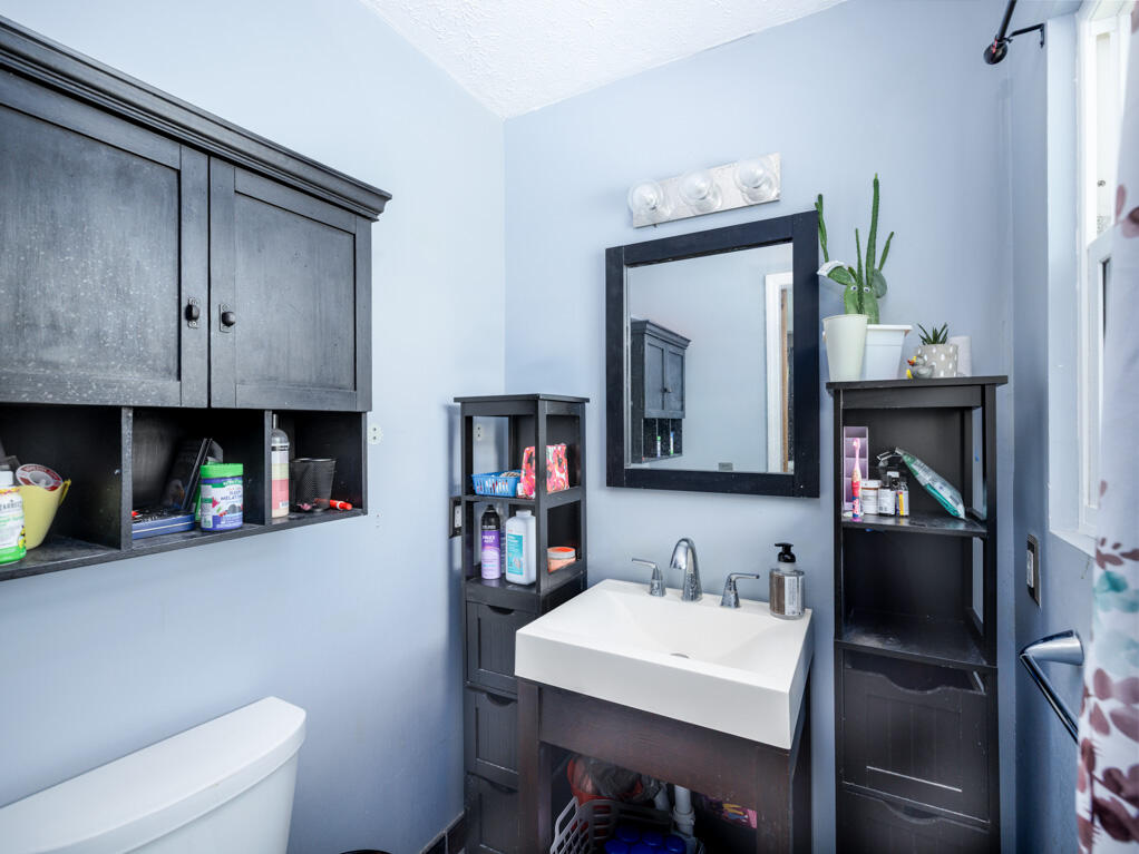 29283 Coconut Palm Drive Big Pine Key, FL 33043 - Photo 21 of 35 a bathroom with a sink a toilet and a mirror