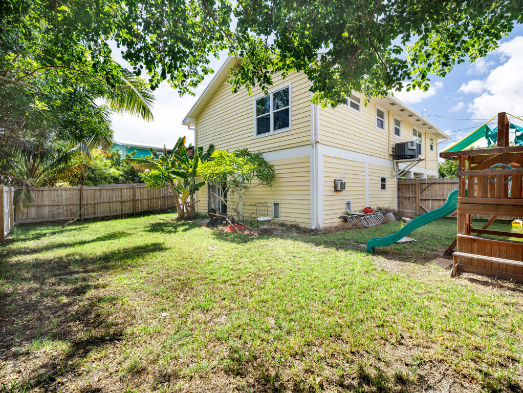29283 Coconut Palm Drive Big Pine Key, FL 33043 - Photo 26 of 35 a view of backyard with wooden fence and a large tree